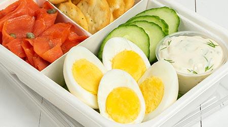 Eggs in a bento box with vegetables and smoked salmon